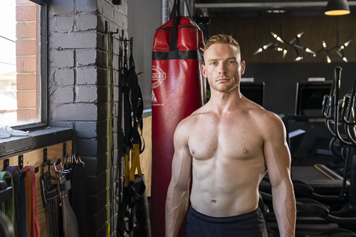 Levi Cox standing beside a punching bag